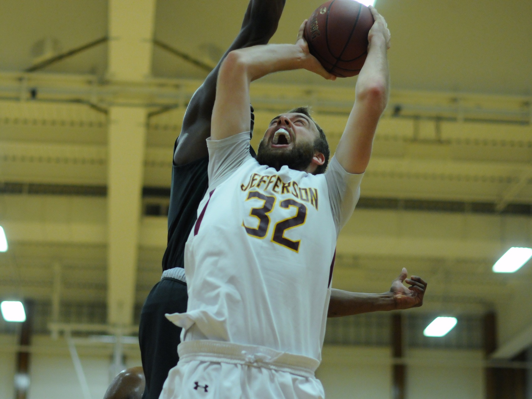 Sophomore #32 Joshua Newman Battles his defender for the basket